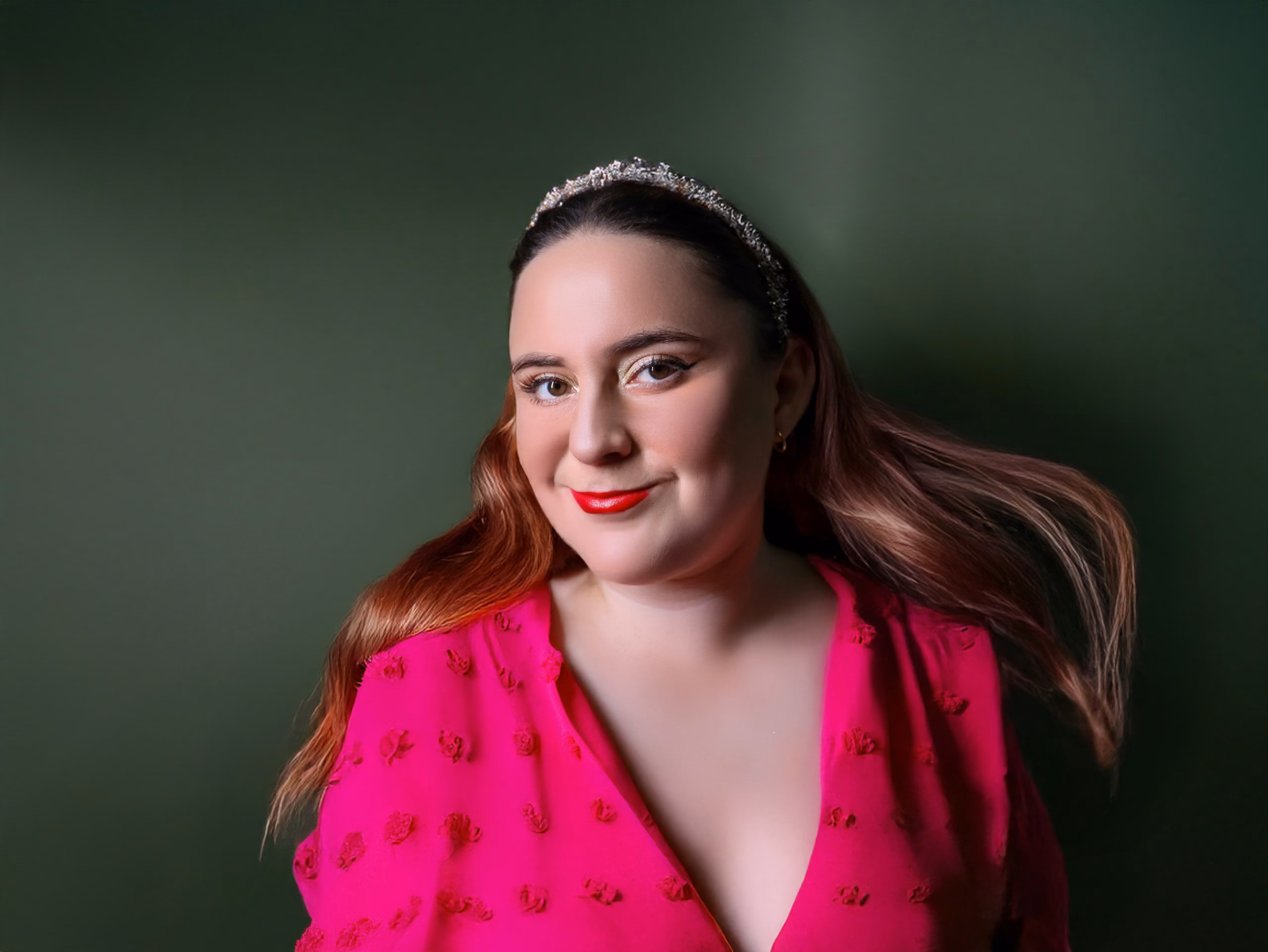Portrait photographed against a solid colored studio backdrop