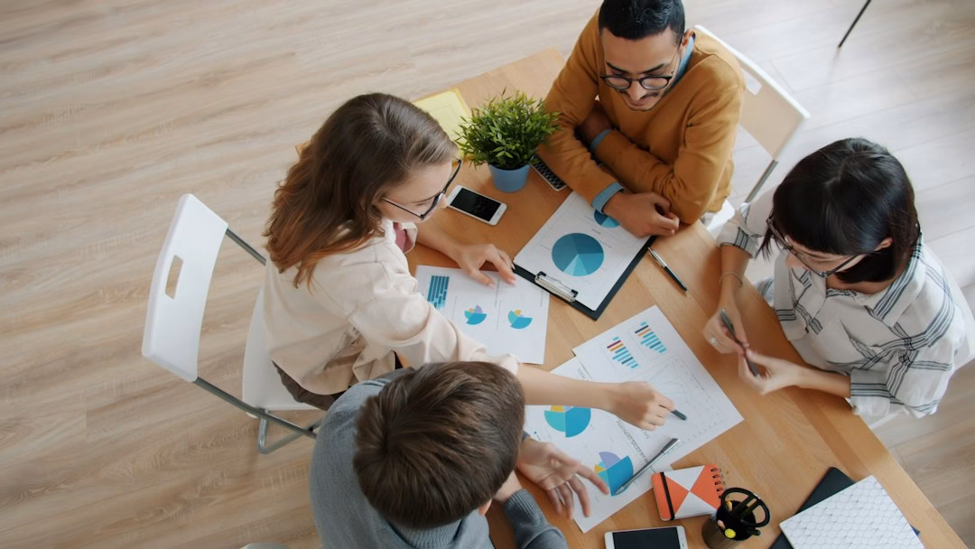 Marketing team analyzing ppc management services dashboard for a client campaign