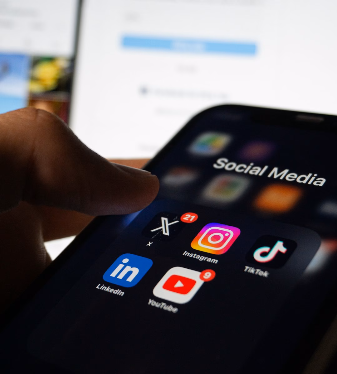 Person holding smartphone showing social media app for TikTok content creation