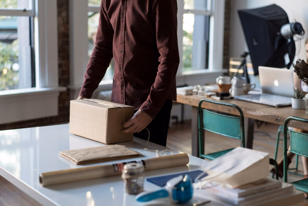 Small business owner packing a product order, representing Product schema markup for e-commerce
