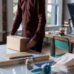 Small business owner packing a product order, representing Product schema markup for e-commerce