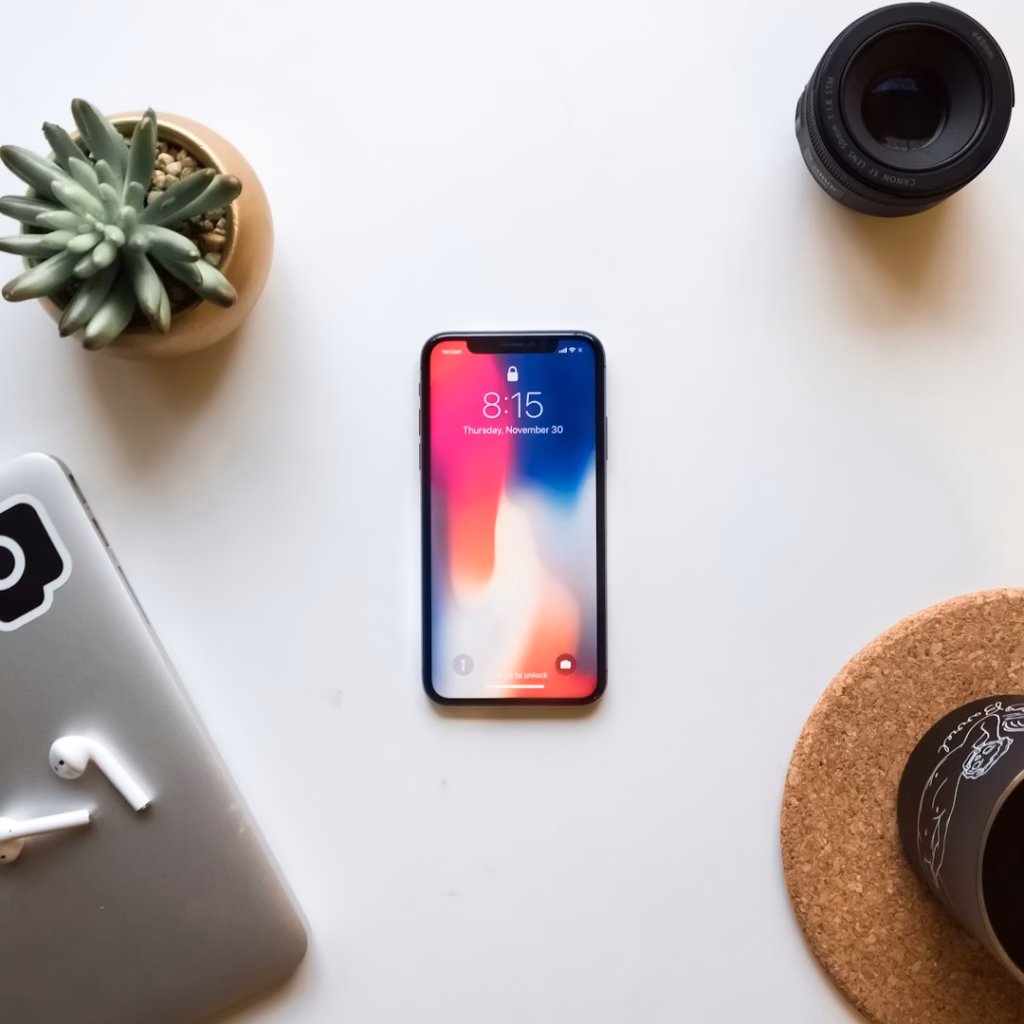 Smartphone on a desk representing a Facebook Page ready for a correctly sized cover photo