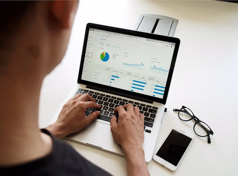 Marketer analyzing a campaign dashboard on a laptop
