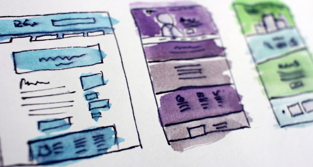 Watercolour wireframe sketches of website page layouts
